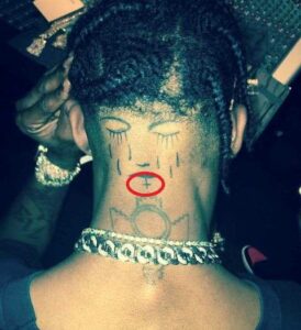 “Upside Down Cross” on the back of his Neck travis scott 